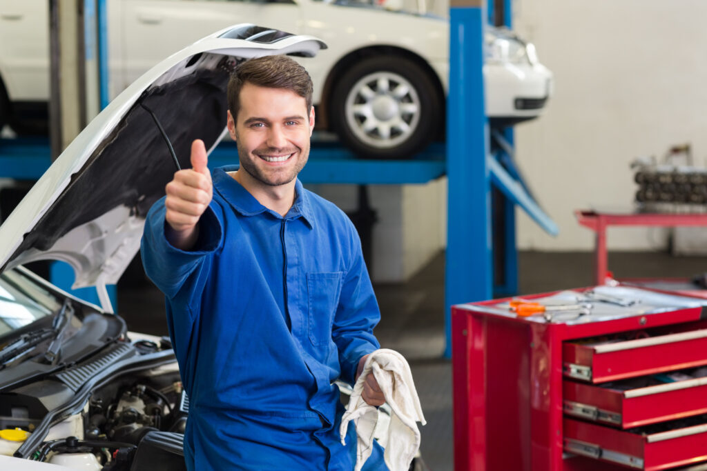 Smiling Mechanic Looking At Camera At The Repair Garage