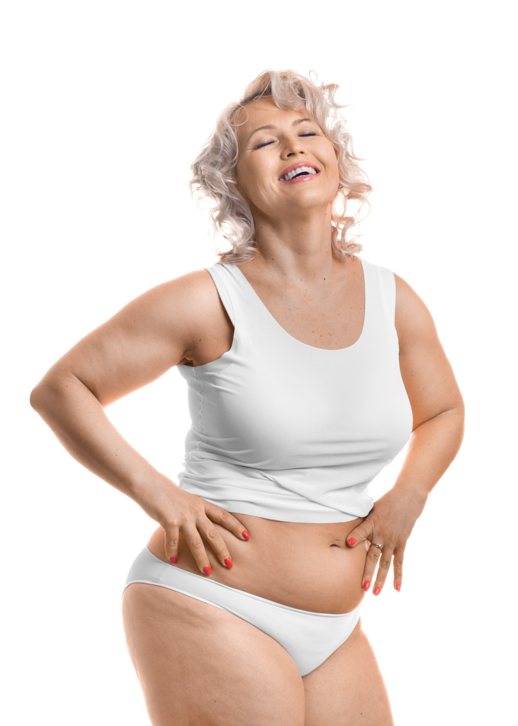 Portrait Of A Happy Laughing Middle Aged Plus Size Model In White Lingerie.