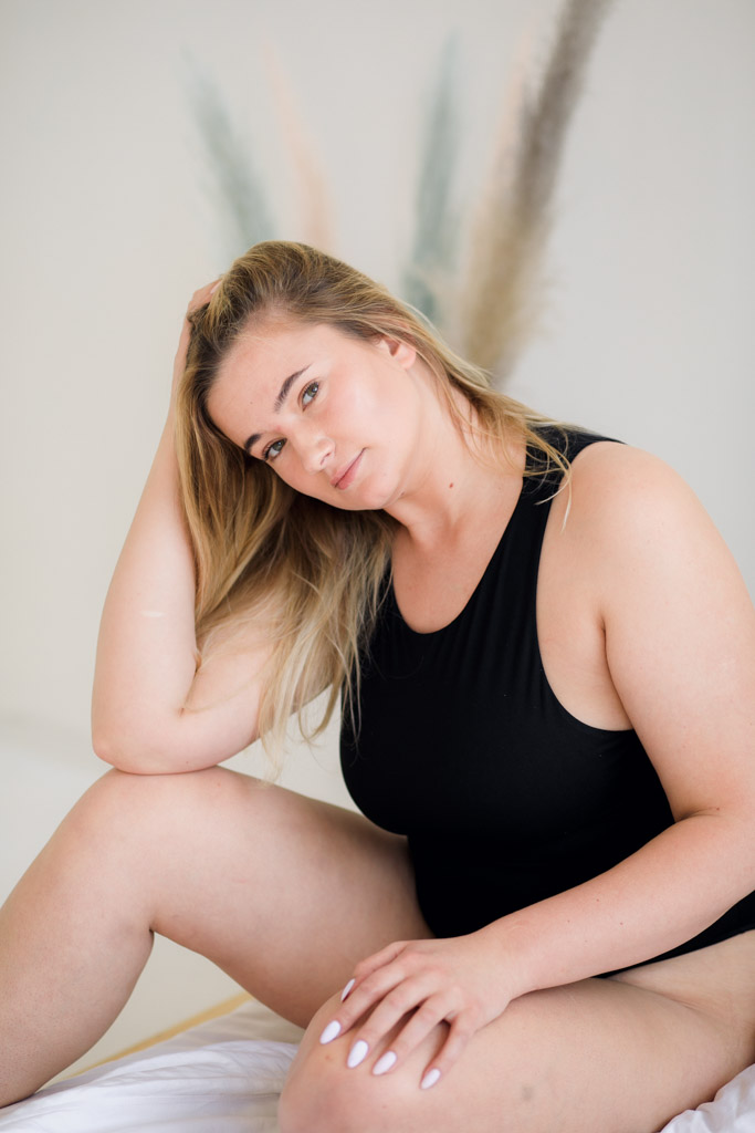 Beautiful Overweight Woman In Black Swimsuit On Grey Background
