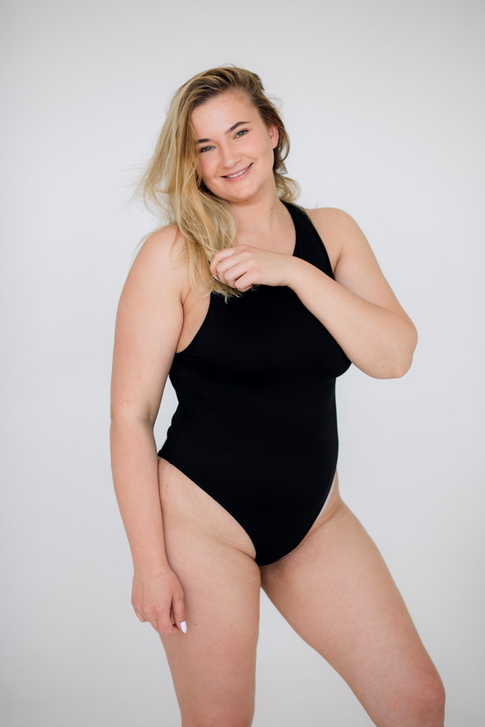 Beautiful Overweight Woman In Black Swimsuit On White Background
